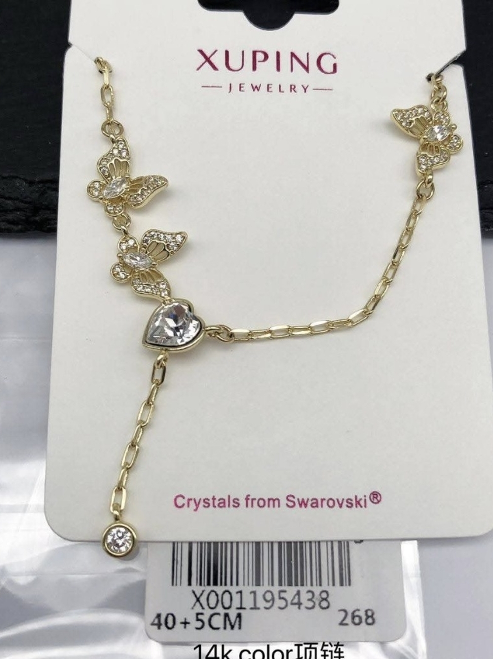Butterfly necklace with a white crystal heart.